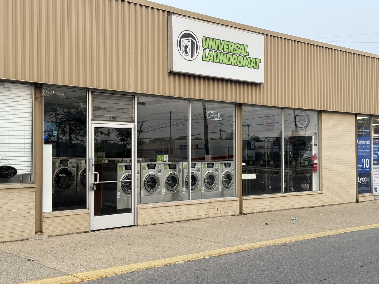 Freshly cleaned laundromat storefront windows in Warren